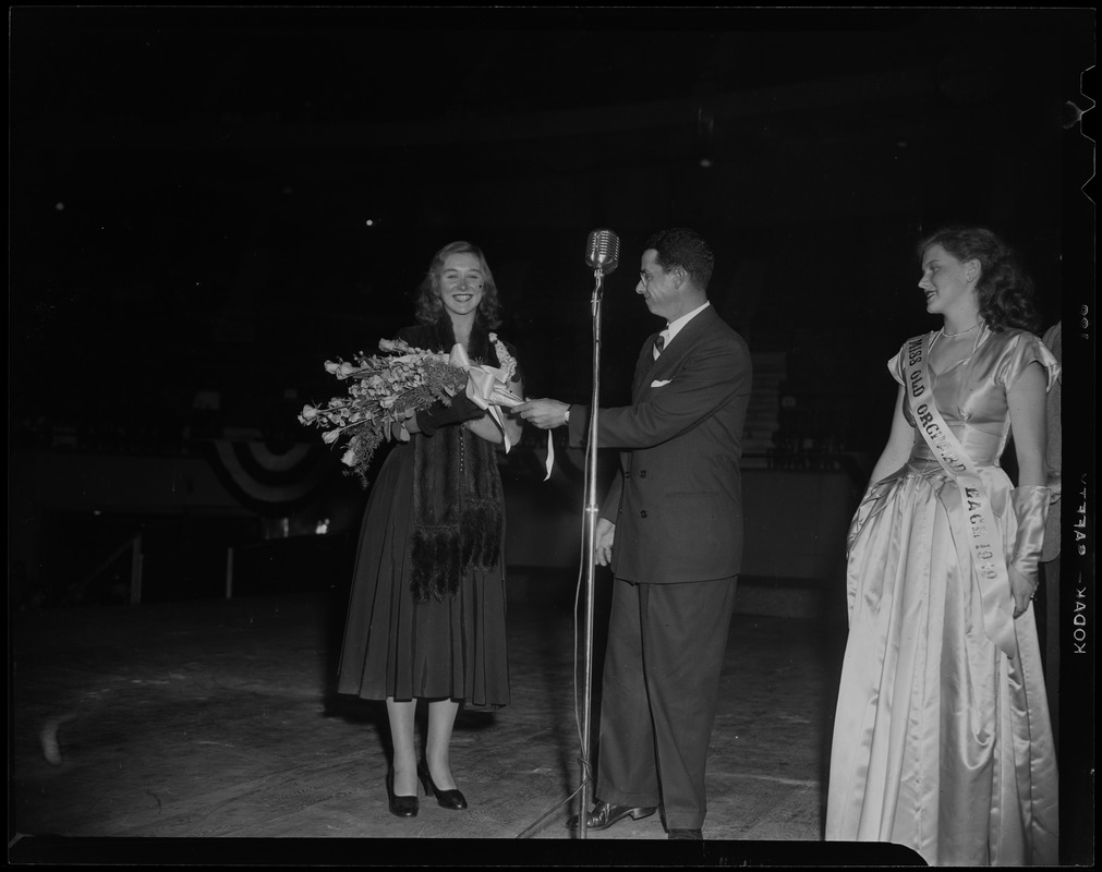Shirley May France holding bouquet of flowers, Dom DiMaggio, and Miss Old Orchard Beach at benefit for Italian orphanage at Boston Garden