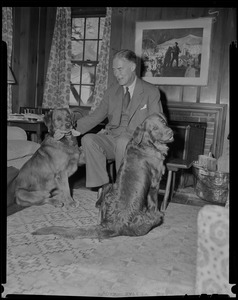 Christian Herter at home with two dogs