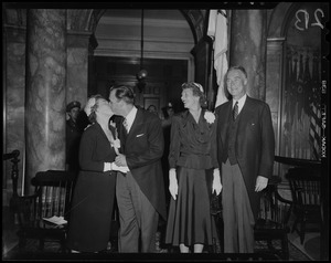 Lt. Gov. Sumner G. Whittier and Jessie Johnston Whittier kissing at inauguration as Gov. Christian Herter and Mary Pratt Herter look on