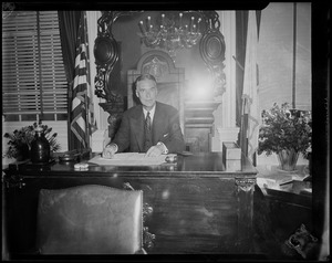 Gov. Christian Herter seated at desk