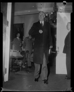 Gov. Christian Herter wearing coat and holding top hat