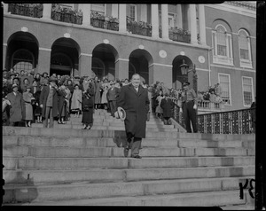 Outgoing Gov. Paul A. Dever descending Massachusetts State House stairs with view of crowds in balcony