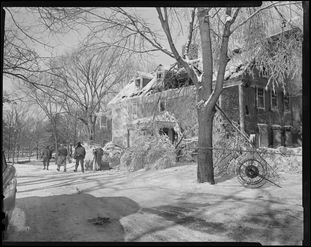 Exterior view of Wayside Inn after fire with three people walking past