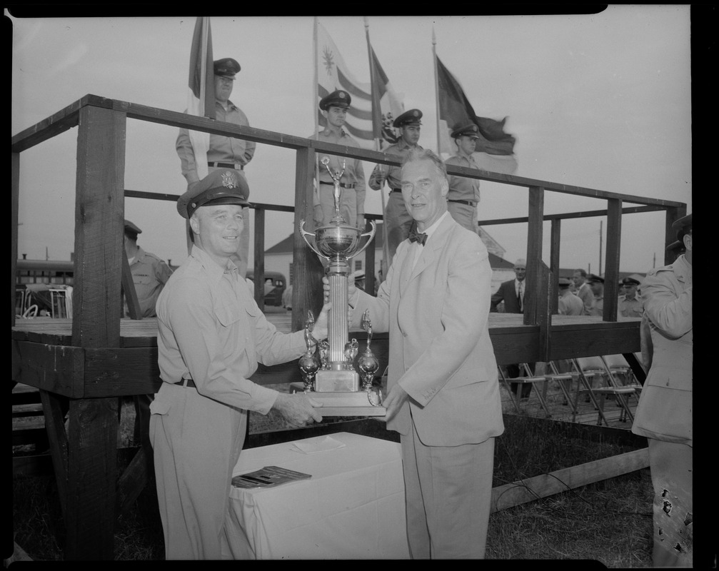 Gov. Herter presents the Gen. Louis E. Boswell combat regimental trophy to Capt. Michael Corcoran, Jr., of Braintree, who accepts on behalf of his unit, Headquarters Squadron, 102nd Air Defense Wing, National Guard, during annual Governor's Day at Otis Field, Cape Cod