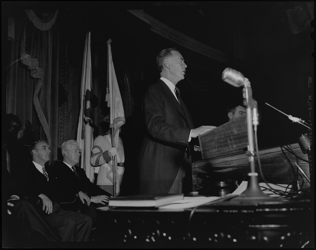 Gov. Christian Herter speaking from podium of House Chamber at State House, with Lt. Gov. Sumner G. Whittier seated behind