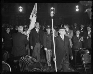 Sergeant-at-arms with top hat and staff, military officer, and Gov. Herter leading procession