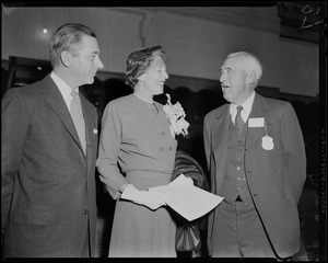 Mary Pratt Herter standing with two men at opening of flower show