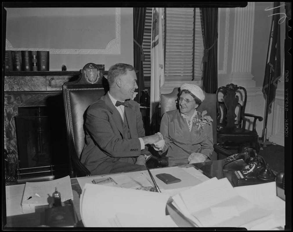 Governor Herter congratulates Mrs. Kate R. Farrington, 80, Cypress st., Cambridge, widowed mother of eight children, who was selected Massachusetts Mother of the Year, during visit to His Excellency at the State House yesterday. She was named by State Federation of Women's Clubs