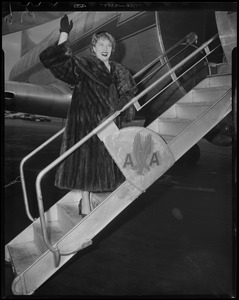 Denise Darcel waving from stairs of American Airlines plane
