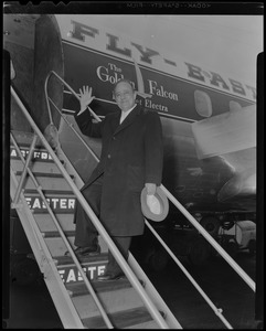 President of Lincoln Downs B. A. Dario boarding Eastern Air Lines plane for Miami