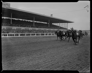Horses racing with crowd in the stands at opening of Lincoln Downs, Rhode Island
