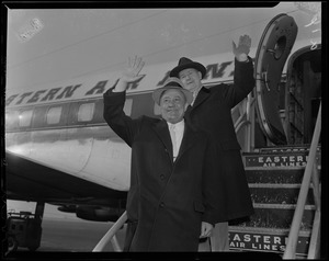 B. A. Dario and Eddie Mack waving from stairs of Eastern Air Lines plane