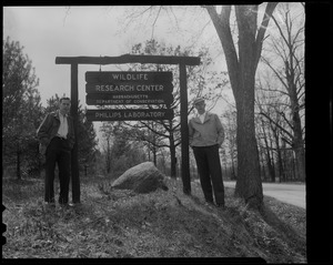 Two men next to sign for Wildlife Research Center - Massachusetts Department of Conservation - Phillips Laboratory