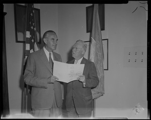 New York Governor Averell Harriman standing with Boston Mayor John B. Hynes in front of flags
