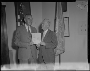 New York Governor Averell Harriman standing with Boston Mayor John B. Hynes in front of flags