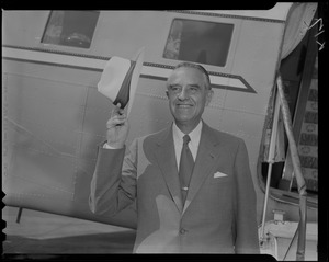 New York Governor Averell Harriman standing near plane and raising his hat