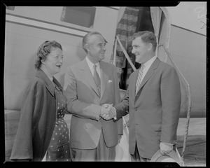 New York Governor Averell Harriman, with his wife Marie Norton Harriman, shaking hands with man near plane