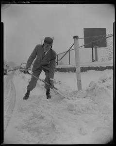 Dr. Paul Dudley White shoveling snow