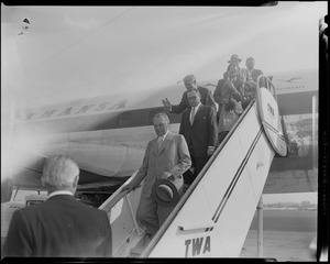 West German Chancellor Konrad Adenauer descending plane ramp with entourage