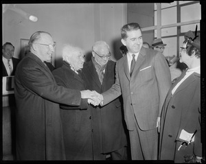 Lt. Governor Robert F. Murphy, David Ben-Gurion, Brandeis President Dr. Abram Sachar, and Deputy Mayor John McMorrow clasping hands, with Paula Ben-Gurion