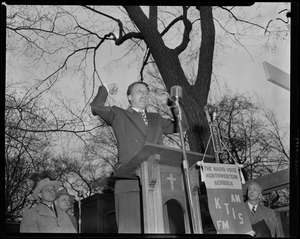 Billy Graham speaking passionately at outdoor podium