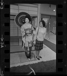 Woman examines mannequin in traditional Japanese garb at War Memorial Auditorium