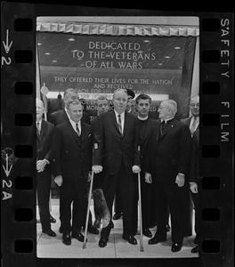 John B. Hynes, Gov. John Volpe, and Mayor John Collins with other dignitaries posing before dedication plaque at War Memorial Auditorium