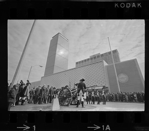 State, city, and federal officials watch as Newport Artillery Company cannon roars out one of 13 rounds saluting the opening of Boston's new War Memorial Auditorium in the Prudential Center, Back Bay, yesterday