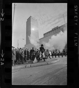 State, city, and federal officials watch as Newport Artillery Company cannon roars out one of 13 rounds saluting the opening of Boston's new War Memorial Auditorium in the Prudential Center, Back Bay, yesterday