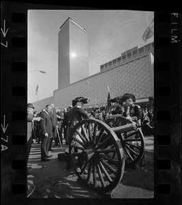 State, city, and federal officials watch as Newport Artillery Company cannon roars out one of 13 rounds saluting the opening of Boston's new War Memorial Auditorium in the Prudential Center, Back Bay, yesterday. First blast was fired by Gov. Volpe and Mayor Collins as thousands flocked to the Boylston St. site for the ceremonies