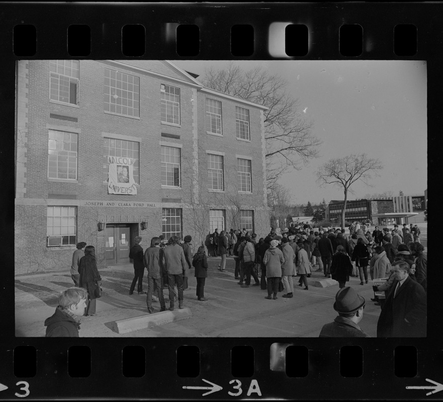 White students parade with placards outside Ford Hall at Brandeis University