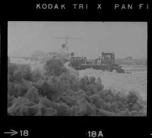 Snow plows working to clear runways at Logan Airport during snow storm