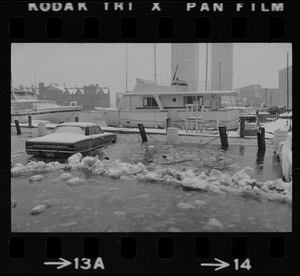 Heavy snowfall and a heavy rain combined with unusually high tide and winds to flood this auto parking lot on Commercial Wharf in Boston