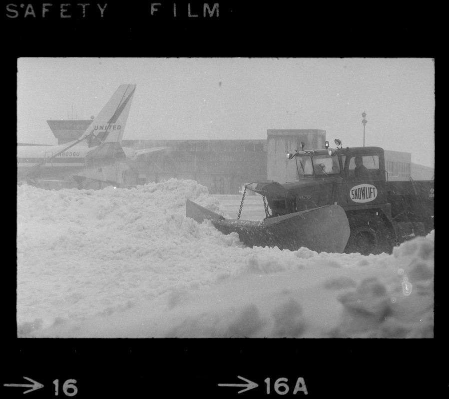 Snow plows working to clear runways at Logan Airport during snow storm