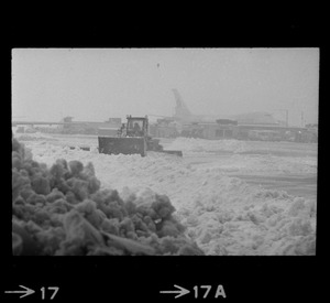 Snow plows working to clear runways at Logan Airport during snow storm