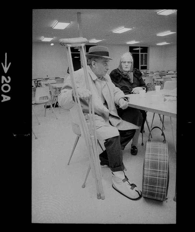 Man with crutches and woman inside during nor'easter