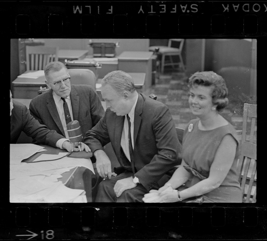 Record American Political Editor Frank Reilly interview Mayor John Collins and wife in editorial room at Record American, which combined with WEEI in giving up-to-the-minute results of election