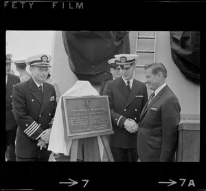 Massachusetts Governor John Volpe presents plaque to Chief Leon I. Smith and unidentified Naval officers at homecoming of U. S. S. Boston at South Boston Naval Annex