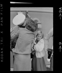 Sailor, woman, and child at homecoming of U. S. S. Boston at South Boston Naval Annex
