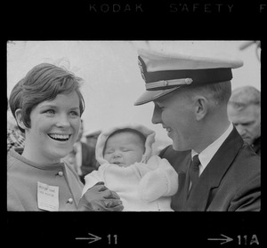 Sailor, woman, and baby at homecoming of U. S. S. Boston at South Boston Naval Annex