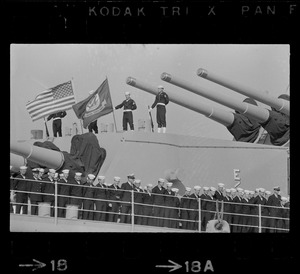 Sailors lined up on deck of guided missile cruiser U. S. S. Boston as it arrives at South Boston Naval Annex