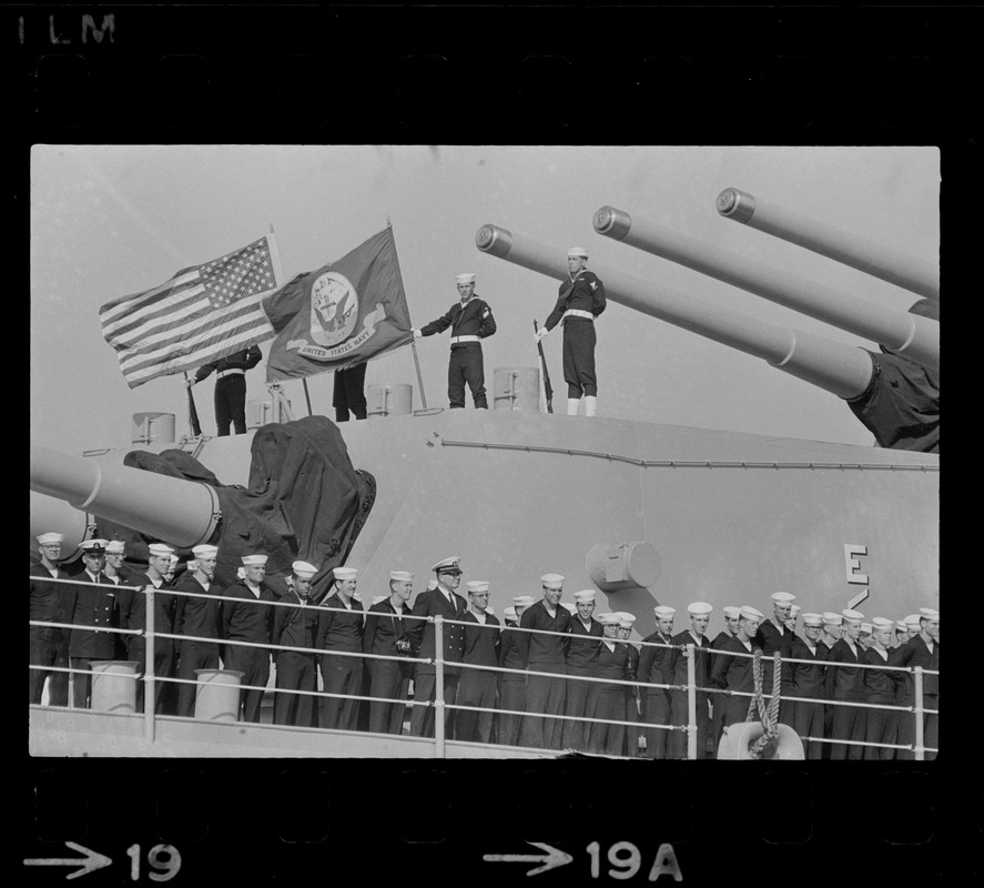 Sailors lined up on deck of guided missile cruiser U. S. S. Boston as it arrives at South Boston Naval Annex