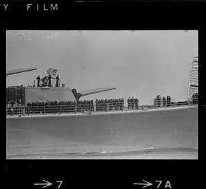 Sailors lined up on deck of guided missile cruiser U. S. S. Boston as it arrives at South Boston Naval Annex