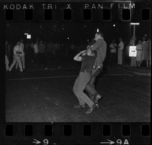 Police officer arresting a man during curfew protest at Boston Common