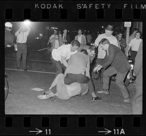 Police officers arresting a man during curfew protest at Boston Common