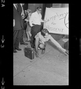 Reporter at pro-Humphrey demonstration outside Somerset Hotel during Richard Nixon campaign rally