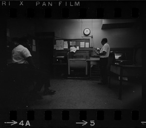 Two unidentified men in photograph developing lab
