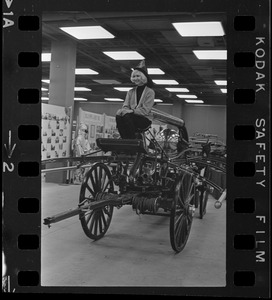 Woman posing on antique fire truck at War Memorial Auditorium