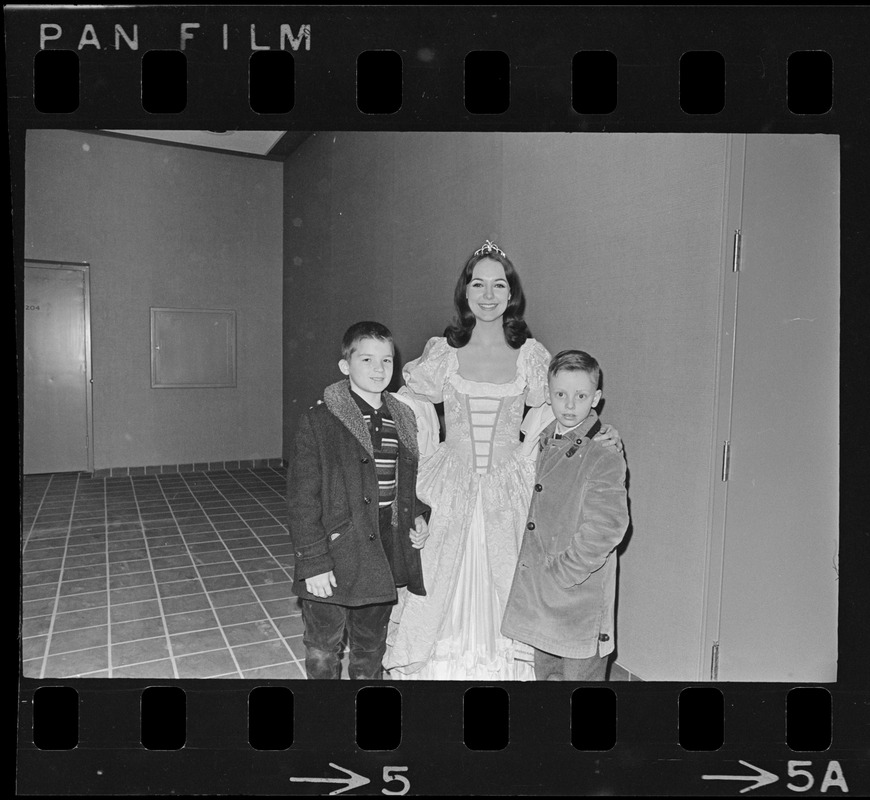 Actor in "Puss in Boots -- The Canterbury Cat" by the Charles Playhouse Musical Theatre for Children at War Memorial Auditorium posing with two children