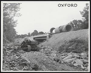 Rt. 20 - Oxford. Bulldozer making temporary road around knocked out bridge